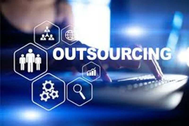 The word outsourcing with team and gear icons over a laptop