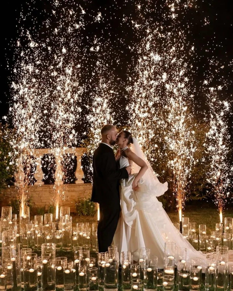 A couple at night among candles and cold-spark fountains